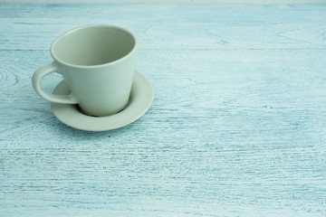 Empty coffee cup on old blue wooden table