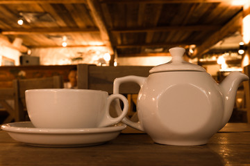 Teapot and cup on wood table