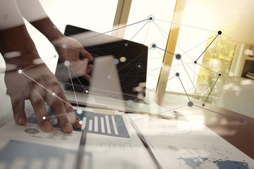 business documents on office table with laptop computer and man