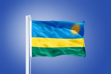 Flag of Rwanda flying against a blue sky