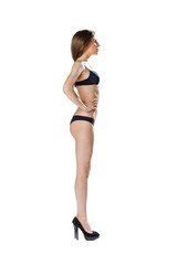 Fototapeta premium Full length portrait of a beautiful young model in black bikini
