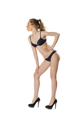 Full length portrait of a beautiful young model in black bikini