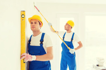 group of builders with tools indoors