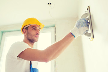 builder working with grinding tool indoors