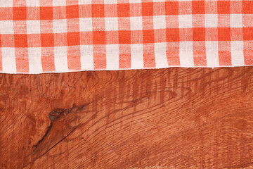 Tablecloth red and white checkered wavy on wooden table