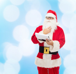 man in costume of santa claus with notepad