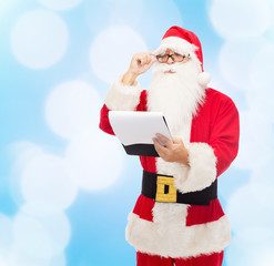 man in costume of santa claus with notepad