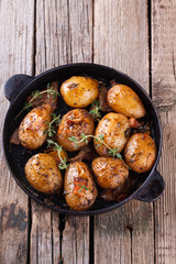 Young potatoes fried in a pan. With garlic, pancetta and thyme.selective focus
