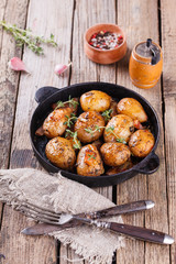 Young potatoes fried in a pan. With garlic, pancetta and thyme.selective focus