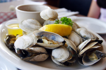 Bowl of Delicious Fresh Steamer Clams with Lemon and Broth..