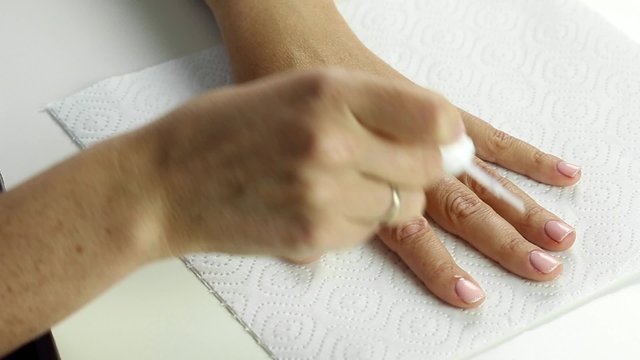 Professional nails care in process - dehydration of female nail after gel polish application procedure