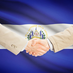 Businessmen handshake with flag on background - El Salvador