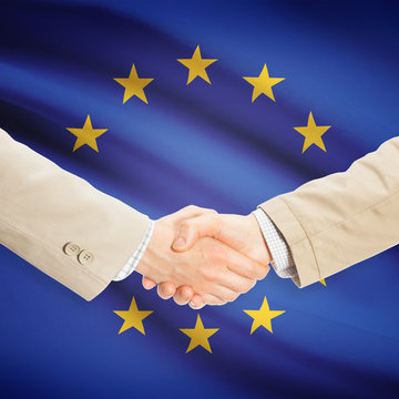 Businessmen handshake with flag on background - EU - European Un