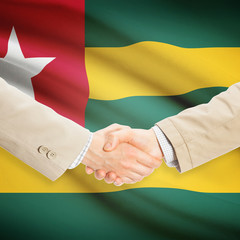 Businessmen handshake with flag on background - Togo