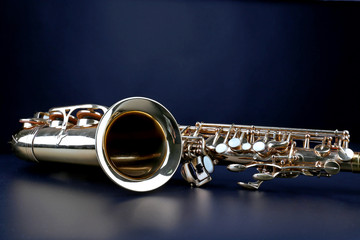 Golden saxophone on dark background