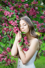 Obraz na płótnie Canvas Young spring fashion woman in spring garden Springtime Summertim