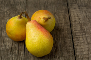 fresh ripe organic pears on a rustic wooden table