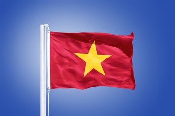 Flag of Vietnam flying against a blue sky