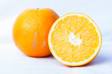 Whole orange fruit and his segments or cantles isolated on white background cutout