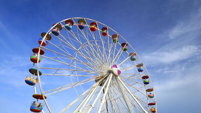 Ferris Wheel at amusement park with blue sky background