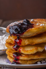 Stack of pancakes with jam and sugar