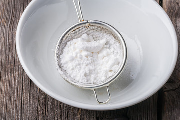 Powdered sugar in a sieve