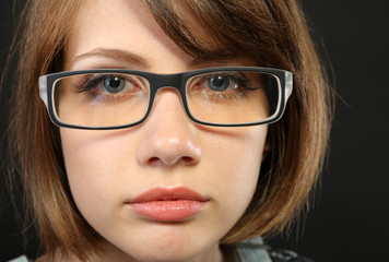 Attractive young woman with glasses close up