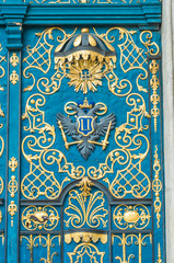 Blue door decorated with golden adornment