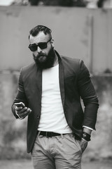 Bearded businessman looking at phone