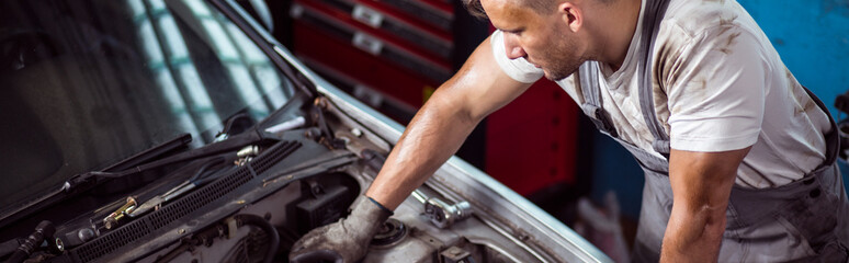 Auto mechanic fixing car engine