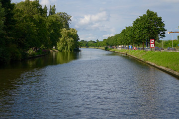 blue river with green trees at the side