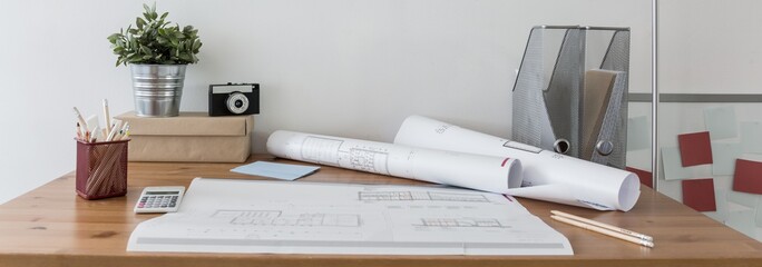 Blueprints on wooden desk