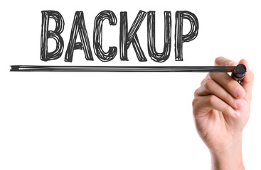 Hand with marker writing the word Backup