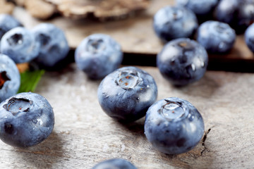 Tasty ripe blueberries on wooden table close up