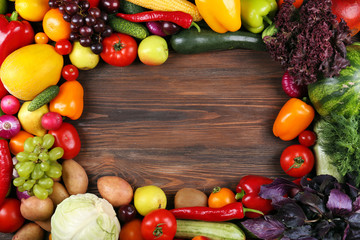 Heap of fruits and vegetables on wooden background