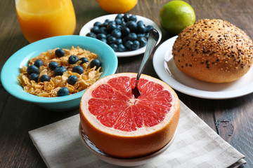 Naklejka na ściany i meble Tasty cornflakes with fruits and berries on table close up
