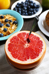 Naklejka na ściany i meble Tasty cornflakes with fruits and berries on table close up