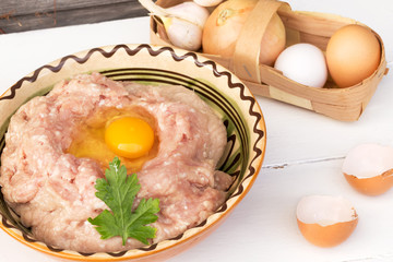 Chicken ground meat for meatballs onion garlic eggs wood backgro
