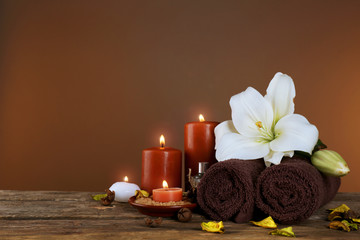 Beautiful spa composition with lily on brown background