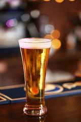 Cold beer glass on bar or pub desk