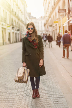 stylish young woman doing shopping in the street