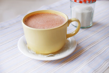 Mug of hot cocoa on table in cafe