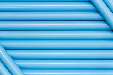Obraz premium Blue pvc pipes in line for background texture