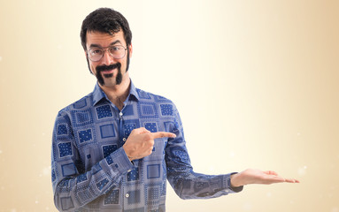 Vintage young man pointing and holding something