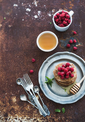 Breakfast set. Buckwheat pancakes with fresh raspberries, honey