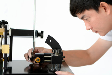 Club Maker checking the loft angle of golf club