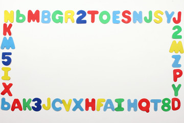 Colorful alphabet letters border on white background with space for text