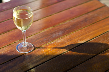 White wine glass on wooden table