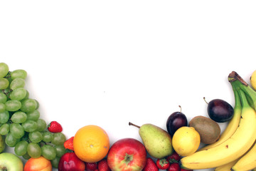 Fresh fruits border on white background with copyspace