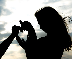 Silhouette of a young mother and daughter 